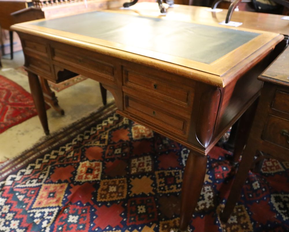 A Continental mahogany writing table, width 120cm, depth 65cm, height 75cm